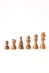 wooden chess pieces isolated against white