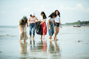 group of volunteer keep clean on sea beach
