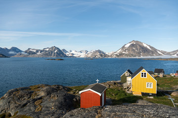 A few colourful houses overseing a beautiful view of glaciers.  © Max