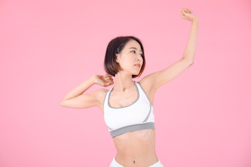 sport woman standing open hands and showing muscle bodybuilding on pink backgrounds, fitness concept, sport concept