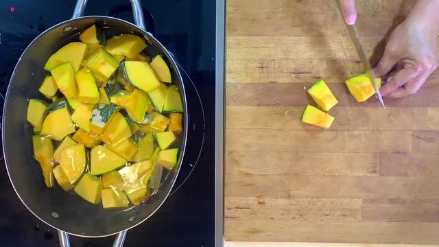 Time-lapse of a pumpkin being cook into a boiling water, saut&eacute;ed to skillet and place in a glass container.