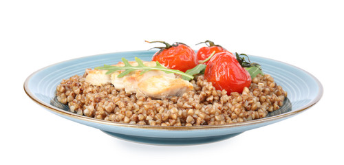 Delicious buckwheat porridge with meat and tomatoes on white background