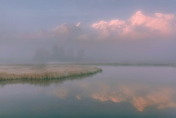 Fototapeta na wymiar lake mountains fog reflection sunrise