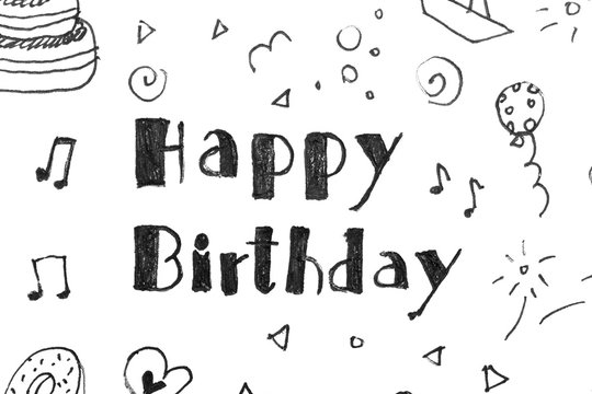 Words HAPPY BIRTHDAY and funny little pictures on white paper, top view