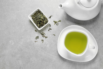 Obraz na płótnie Canvas Flat lay composition with green tea on grey background