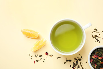 Flat lay composition with green tea and lemon on beige background