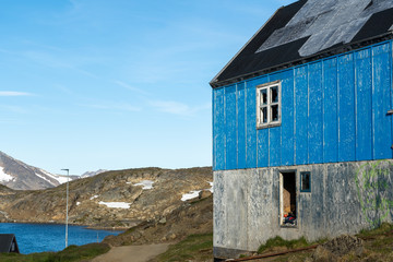 Wide shot of an abandoned house in Kulusuk, Greenland. 