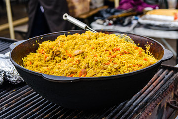 Big pan with pilaf on street festival