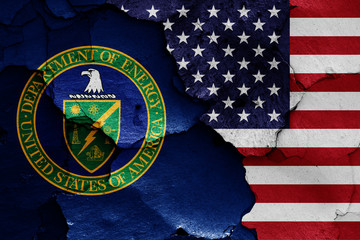 flags of Department of Energy and USA painted on cracked wall
