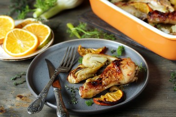 dish with fennel. Baked chicken drumsticks with fennel and oranges. festive dish, popular in the Mediterranean. Keto diet dish. ceramic baking dish.