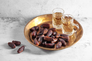 dates fruit and Arab tea on a white concrete background with a blank space for a text, dates fruit on a white background