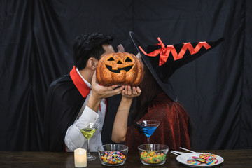 Couple in costume witch and dracula with kissed in celebrate party Halloween.