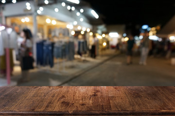 Empty dark wooden table in front of abstract blurred bokeh background of restaurant . can be used for display or montage your products.Mock up for space.
