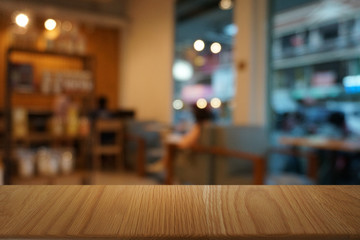 Empty dark wooden table in front of abstract blurred bokeh background of restaurant . can be used for display or montage your products.Mock up for space.