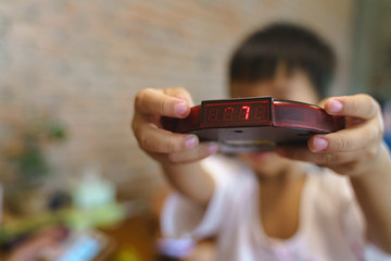 Kid hand holding restaurant queue wireless pager