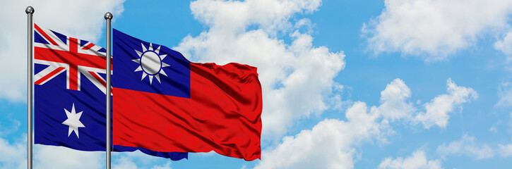 Naklejka premium Australia and Taiwan flag waving in the wind against white cloudy blue sky together. Diplomacy concept, international relations.