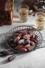 dates fruit and Arab tea on a white concrete background with a blank space for a text, dates fruit on a white background