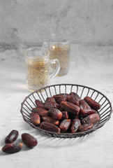 dates fruit and Arab tea on a white concrete background with a blank space for a text, dates fruit on a white background