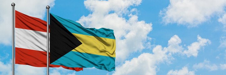 Austria and Bahamas flag waving in the wind against white cloudy blue sky together. Diplomacy concept, international relations.