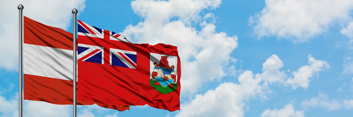 Austria and Bermuda flag waving in the wind against white cloudy blue sky together. Diplomacy concept, international relations.