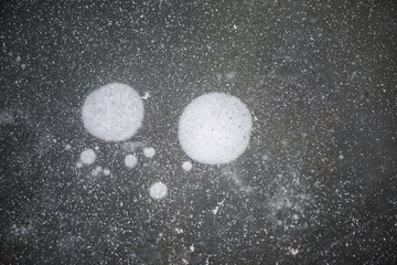 The background of naturally formed ice flower texture on the frozen river in winter