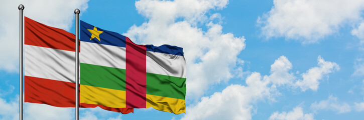 Obraz premium Austria and Central African Republic flag waving in the wind against white cloudy blue sky together. Diplomacy concept, international relations.