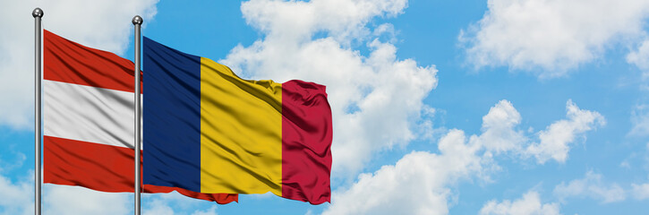 Austria and Chad flag waving in the wind against white cloudy blue sky together. Diplomacy concept, international relations.
