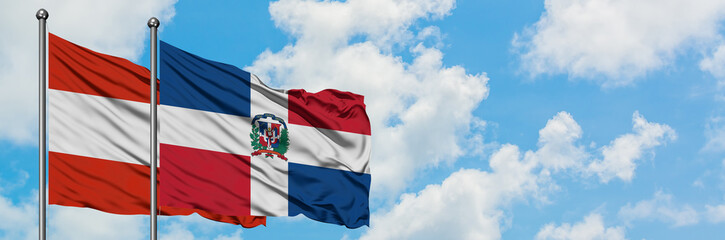 Austria and Dominican Republic flag waving in the wind against white cloudy blue sky together. Diplomacy concept, international relations.
