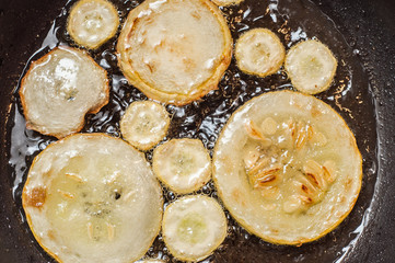 Fry home sliced zucchini in a pan in sunflower oil.