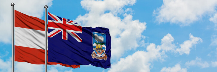 Austria and Falkland Islands flag waving in the wind against white cloudy blue sky together. Diplomacy concept, international relations.
