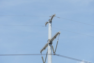 electricity pylon and power lines on background of sky