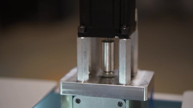 Black stepper motor for desktop cnc mill spinning in slow motion