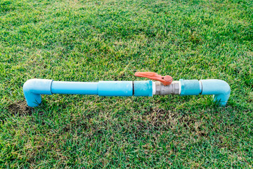 PVC water valve with pipeline in backyard or garden