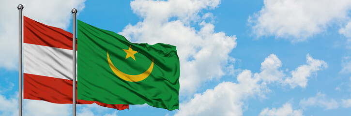 Austria and Mauritania flag waving in the wind against white cloudy blue sky together. Diplomacy concept, international relations.