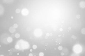 Silver light christmas background with white blur bokeh beautiful glow sparkle. Winter concept. Backdrop for ads, cosmetic, advertising design, beauty, promotion. Product display or montage