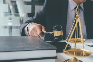 Judge gavel with Justice lawyers having team meeting at law firm background. Concepts of Law and Legal services.