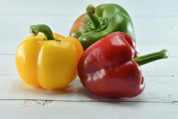 Closeup  fresh  Red, Yellow, Green, bell pepper or sweet pepper or capsicum  isolate on  wood white background,raw food ingredient concept