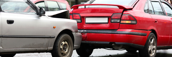 Accident of red and silver car after rain