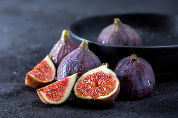 Close up view of fresh figs on dark background