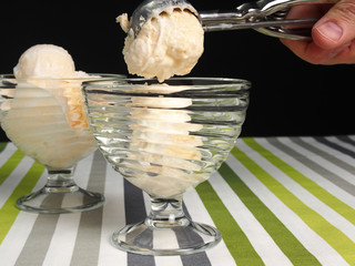 Fototapeta na wymiar Scooping ice cream into bowl
