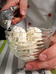 Fototapeta na wymiar Scooping ice cream into bowl