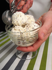 Scooping ice cream into bowl