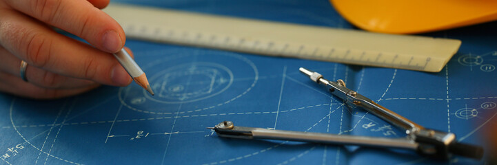 Male hand holding pencil in hand.