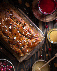 Dark photo of delicious healthy sugarfree apple cake with cinnamon cranberry and rye flour