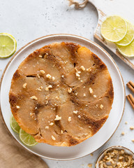 Healthy apple pie with apple slices and lemon zest decorated with cinnamon powder and melted nutsnuts