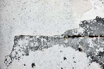 Texture of a concrete wall with cracks and scratches which can be used as a background