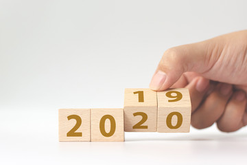 New year 2019 change to 2020 concept. Hand flip over wood cube block