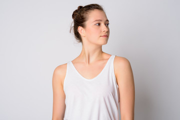 Fototapeta premium Face of young beautiful woman with hair tied thinking