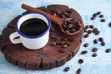 Coffee in cup and coffee bean on rustic table with a blank space for a text, Espresso in cup on blue background