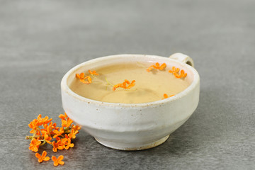 cup of hot tea with osmanthus flower, aromatic relaxation drink